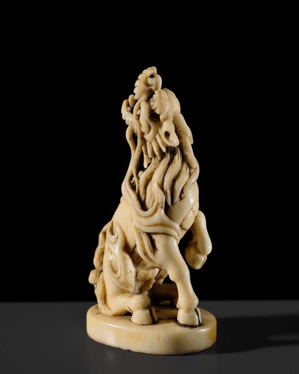 Lot 98 - A SUPERB IVORY SEAL-TYPE (INGYO) NETSUKE OF A KIRIN