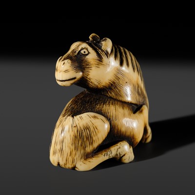 A KYOTO SCHOOL IVORY NETSUKE OF A RECLINING HORSE
