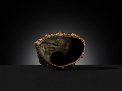 Lot 12 - AN INCSCRIBED GILT-COPPER FIGURE OF BUDDHA SHAKYAMUNI, NEPAL, LATE 13TH-EARLY 14TH CENTURY