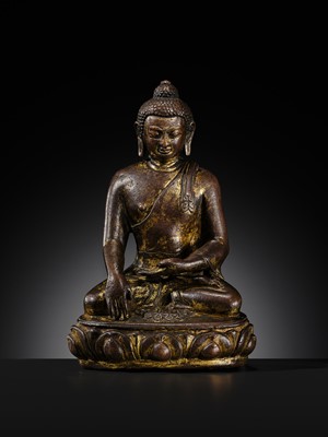 Lot 12 - AN INCSCRIBED GILT-COPPER FIGURE OF BUDDHA SHAKYAMUNI, NEPAL, LATE 13TH-EARLY 14TH CENTURY