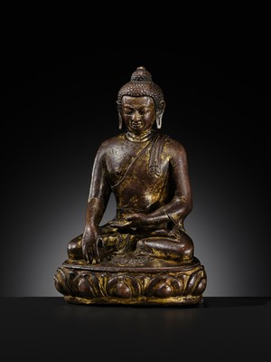 Lot 12 - AN INCSCRIBED GILT-COPPER FIGURE OF BUDDHA SHAKYAMUNI, NEPAL, LATE 13TH-EARLY 14TH CENTURY