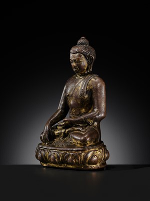 Lot 12 - AN INCSCRIBED GILT-COPPER FIGURE OF BUDDHA SHAKYAMUNI, NEPAL, LATE 13TH-EARLY 14TH CENTURY