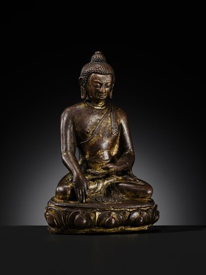 Lot 12 - AN INCSCRIBED GILT-COPPER FIGURE OF BUDDHA SHAKYAMUNI, NEPAL, LATE 13TH-EARLY 14TH CENTURY