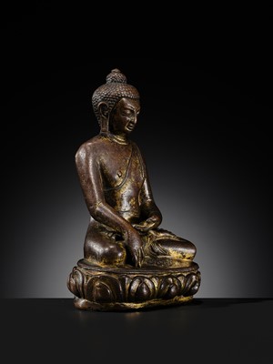 Lot 12 - AN INCSCRIBED GILT-COPPER FIGURE OF BUDDHA SHAKYAMUNI, NEPAL, LATE 13TH-EARLY 14TH CENTURY