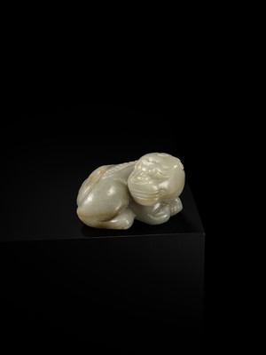 A CELADON JADE CARVING OF A BUDDHIST LION, LATE MING TO EARLY QING DYNASTY