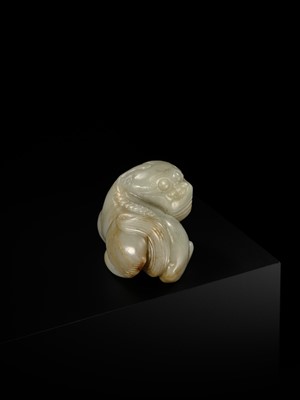 A CELADON JADE CARVING OF A BUDDHIST LION, LATE MING TO EARLY QING DYNASTY