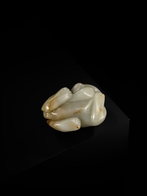 A CELADON JADE CARVING OF A BUDDHIST LION, LATE MING TO EARLY QING DYNASTY