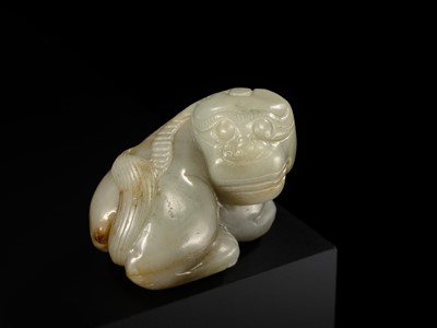 A CELADON JADE CARVING OF A BUDDHIST LION, LATE MING TO EARLY QING DYNASTY