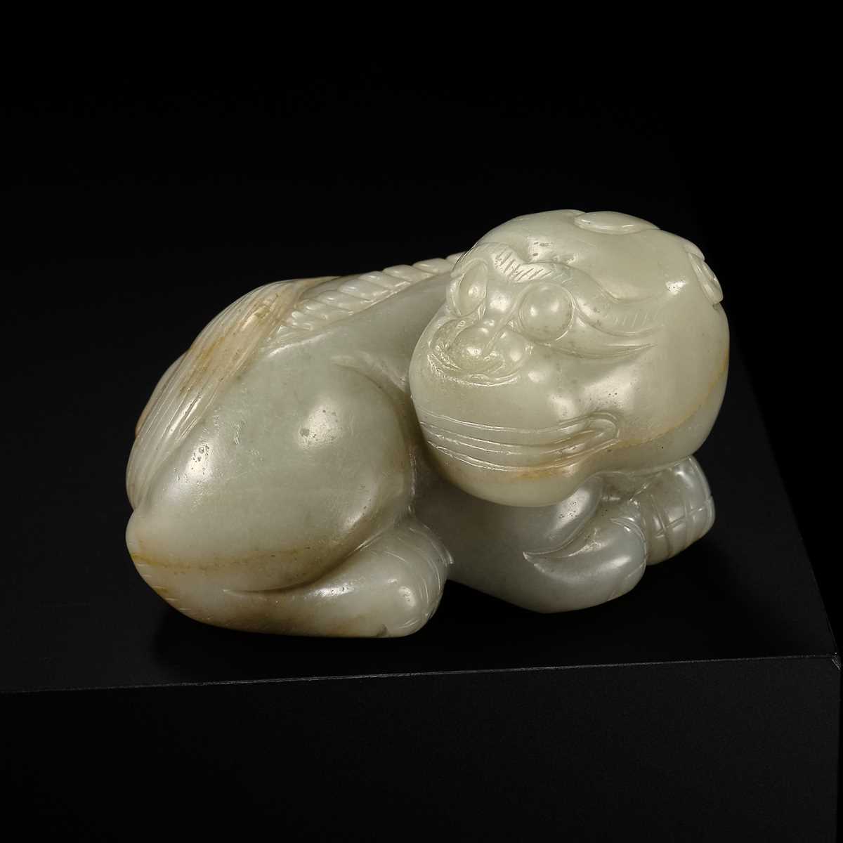 A CELADON JADE CARVING OF A BUDDHIST LION, LATE MING TO EARLY QING DYNASTY