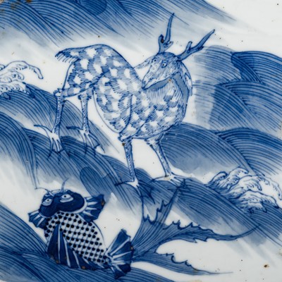 Lot 232 - AN UNUSUAL BLUE AND WHITE PORCELAIN TILE WITH MYTHICAL BEAST AND CARP, 16TH - 17TH CENTURY