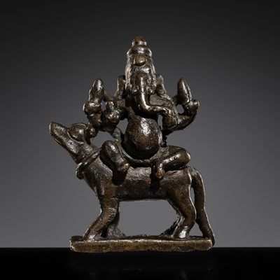 Lot 334 - A SMALL BRONZE FIGURE OF GANESHA ON HIS RAT VAHANA, SOUTH INDIA, CIRCA 16TH CENTURY