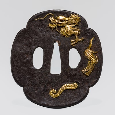 Lot 576 - A JAKUSHI SCHOOL IRON ‘DRAGON’ TSUBA