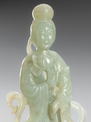Lot 975 - A PALE CELADON JADE FIGURE OF GUANYIN, LATE QING DYNASTY