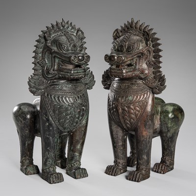 Lot 1332 - A PAIR OF BRONZE GUARDIAN LIONS, KHMER-STYLE