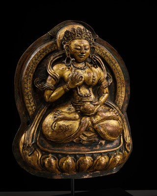 Lot 18 - A GILT-COPPER REPOUSSÉ PLAQUE OF WHITE TARA, TIBET, 18TH CENTURY