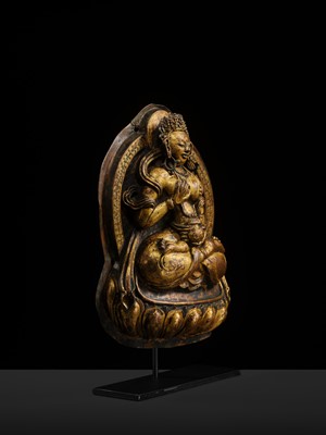 Lot 18 - A GILT-COPPER REPOUSSÉ PLAQUE OF WHITE TARA, TIBET, 18TH CENTURY