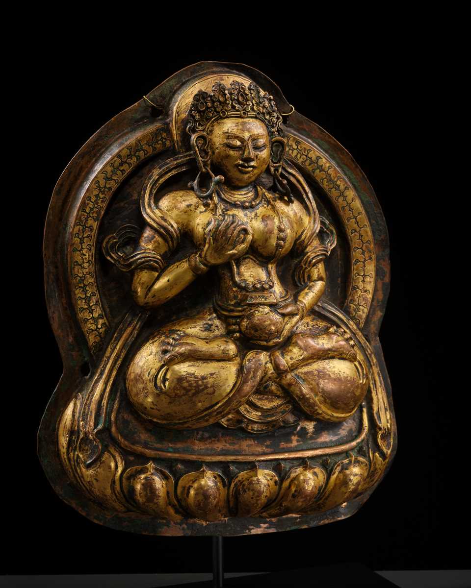 Lot 18 - A GILT-COPPER REPOUSSÉ PLAQUE OF WHITE TARA, TIBET, 18TH CENTURY