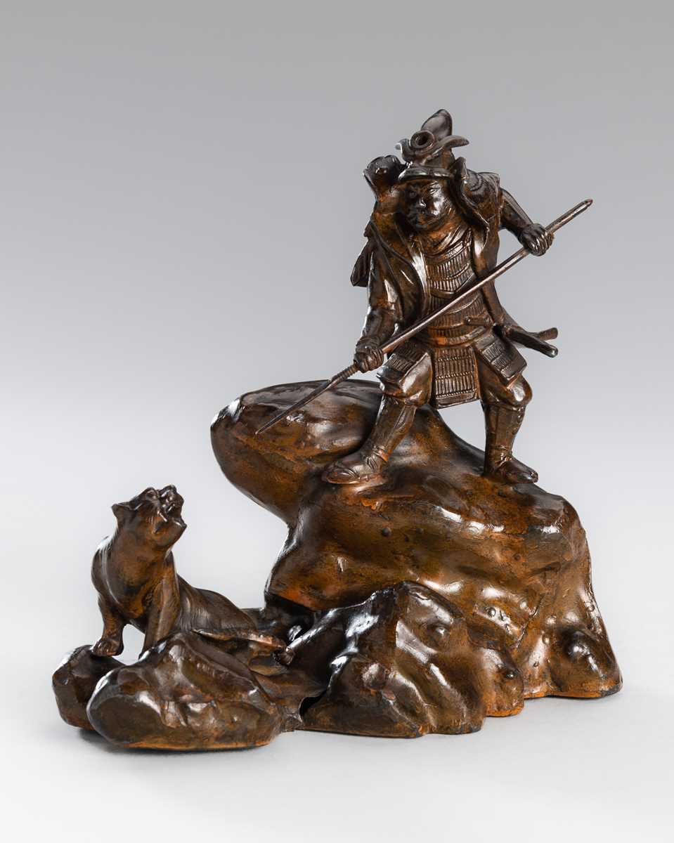 Lot 32 - A BRONZE OKIMONO OF A SAMURAI HUNTING A TIGER