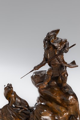 Lot 32 - A BRONZE OKIMONO OF A SAMURAI HUNTING A TIGER