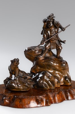 Lot 32 - A BRONZE OKIMONO OF A SAMURAI HUNTING A TIGER