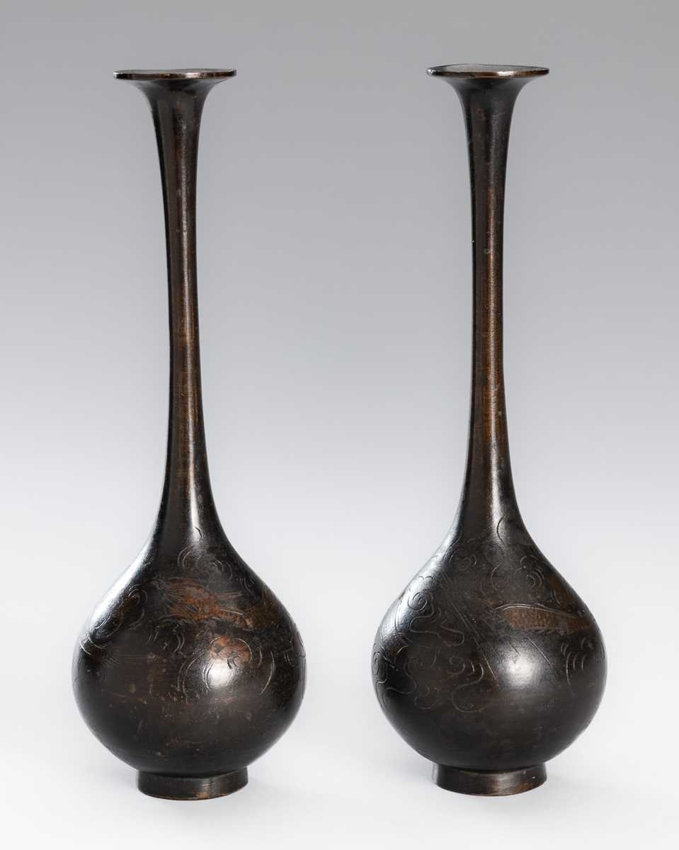 Lot 10 - A PAIR OF BRONZE TRUMPET BOTTLE VASES WITH DRAGONS AMONG CLOUDS