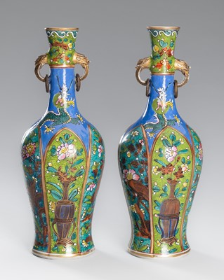 Lot 1021 - A PAIR OF ENAMELED PORCELAIN VASES WITH FLOWERS AND DRAGONS