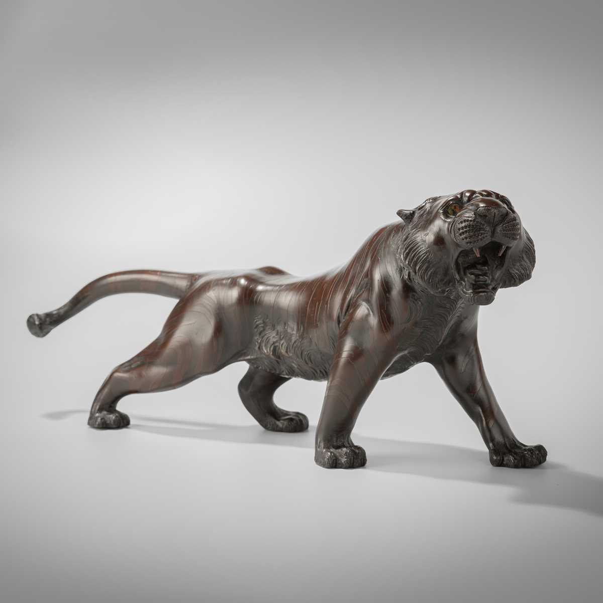 Lot 41 - A PATINATED BRONZE MODEL OF A ROARING TIGER