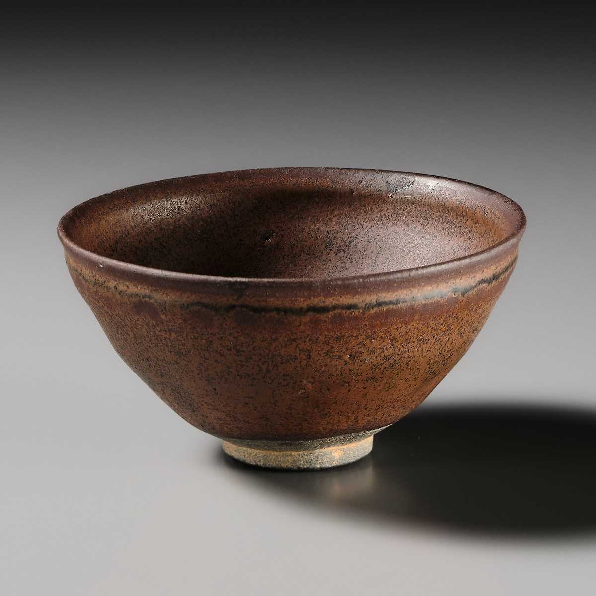 Lot 229 - A JIAN PERSIMMON-GLAZED STONEWARE TEA BOWL, SONG DYNASTY