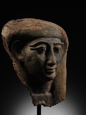 Lot 14 - A BRONZE AND LIMESTONE INLAID WOOD SARCOPHAGUS MASK, PTOLEMAIC PERIOD
