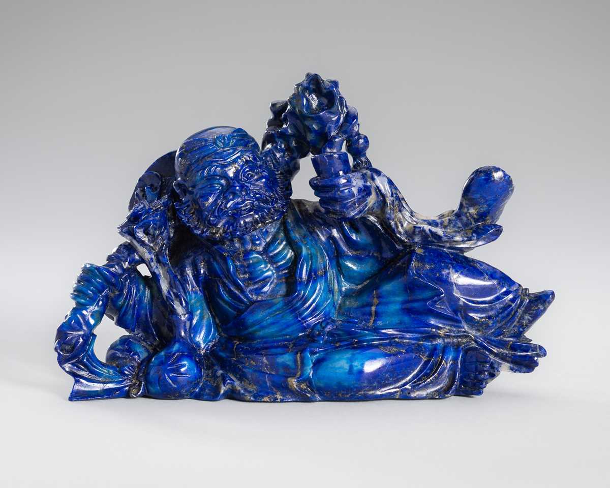 Lot 906 - A LAPIS LAZULI FIGURE OF AN IMMORTAL, c.1900s