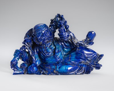 Lot 906 - A LAPIS LAZULI FIGURE OF AN IMMORTAL, c.1900s