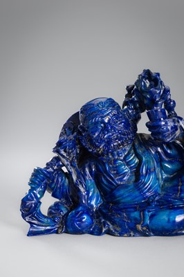Lot 906 - A LAPIS LAZULI FIGURE OF AN IMMORTAL, c.1900s