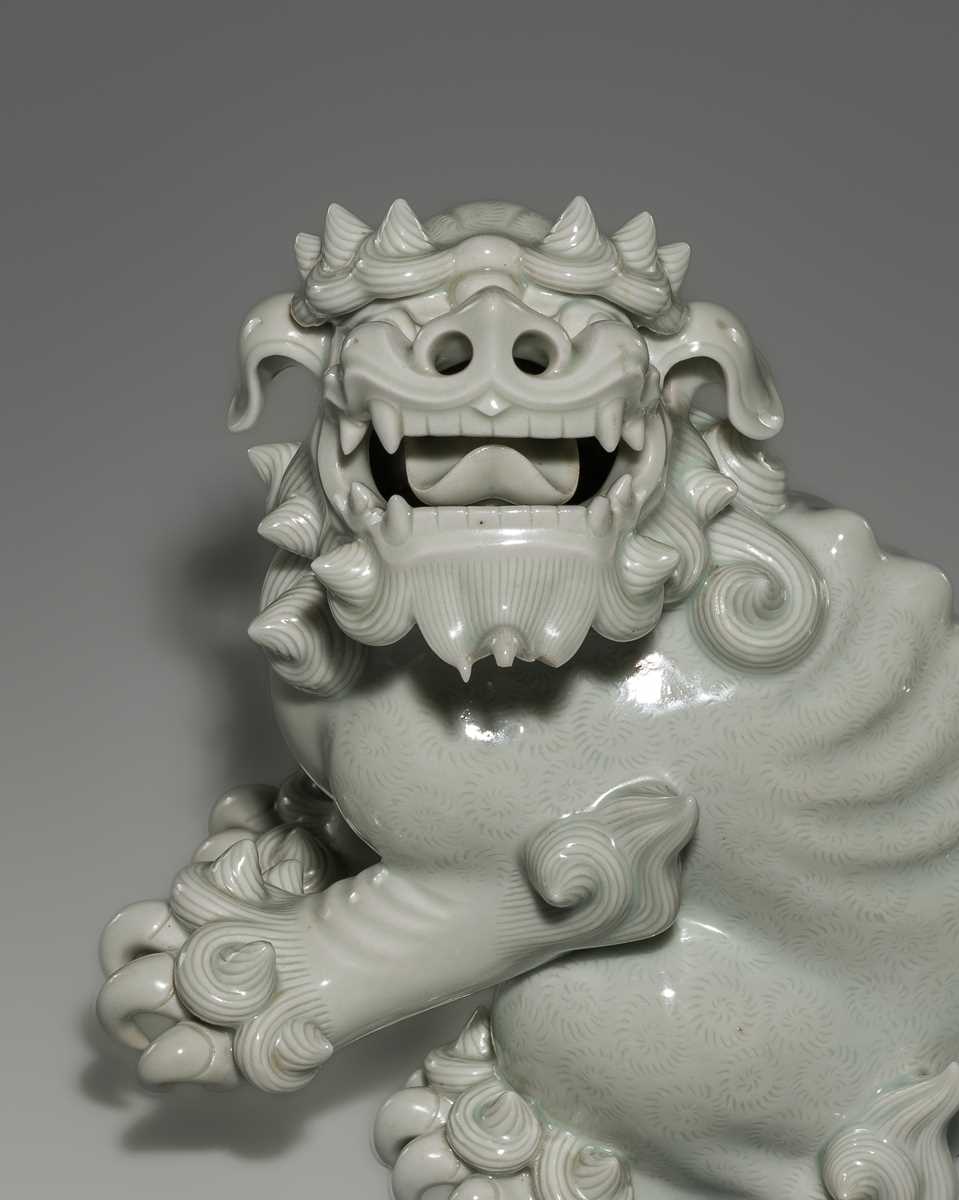 Lot 1584 - A CHARMING HIRADO WHITE-GLAZED OKIMONO OF A SHISHI