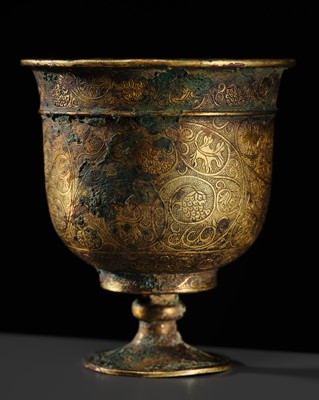 Lot 95 - A FINELY ENGRAVED GILT-BRONZE STEM CUP, TANG DYNASTY