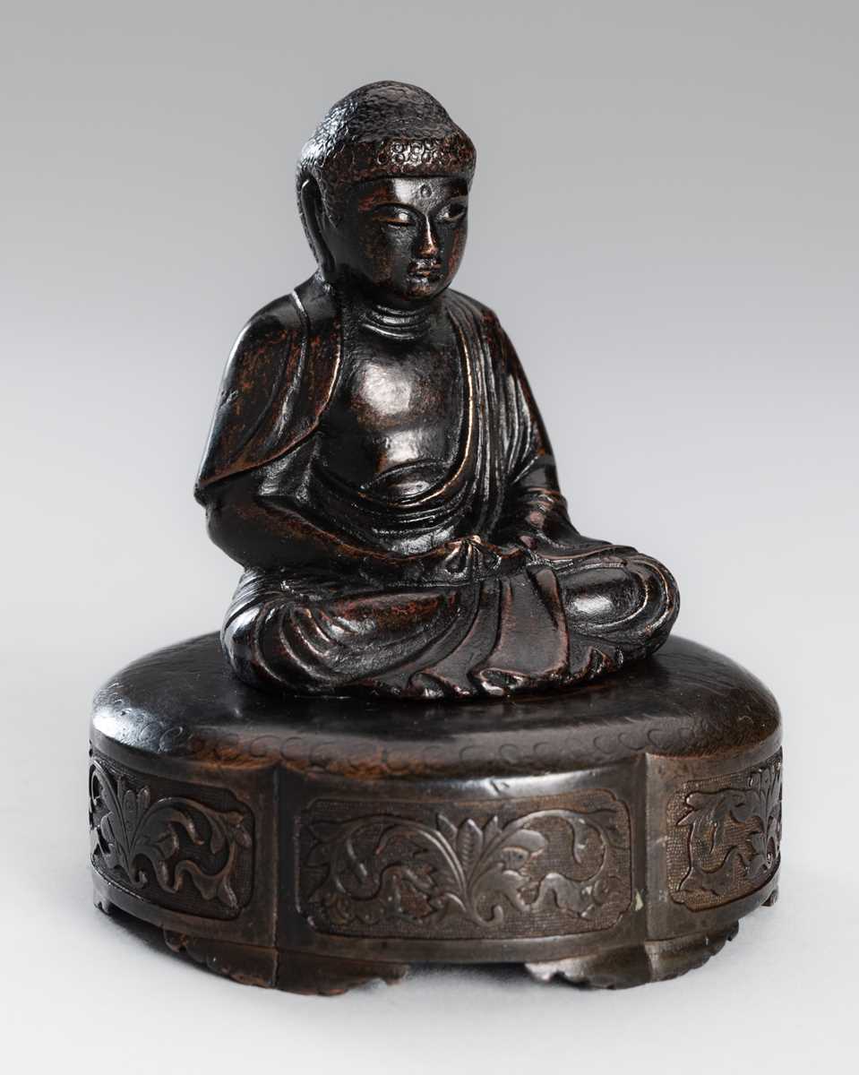 A SMALL COPPER ALLOY FIGURE OF BUDDHA