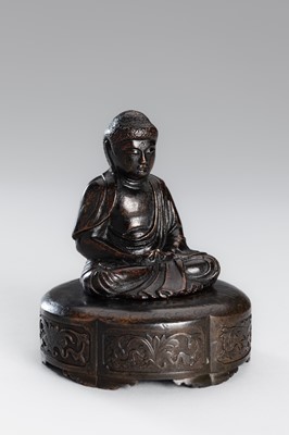 A SMALL COPPER ALLOY FIGURE OF BUDDHA