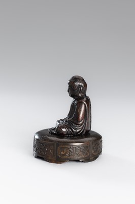 A SMALL COPPER ALLOY FIGURE OF BUDDHA