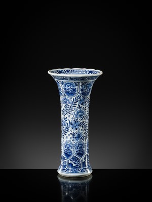 Lot 27 - A BLUE AND WHITE FLUTED AND MOLDED BEAKER VASE, KANGXI PERIOD
