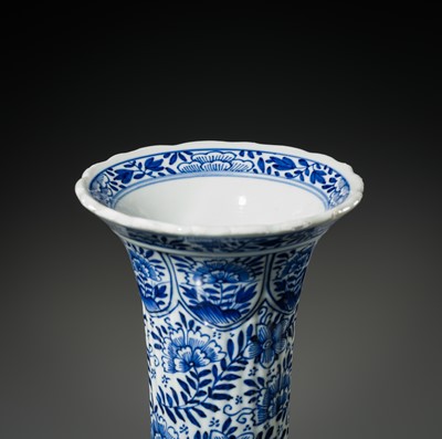 Lot 27 - A BLUE AND WHITE FLUTED AND MOLDED BEAKER VASE, KANGXI PERIOD