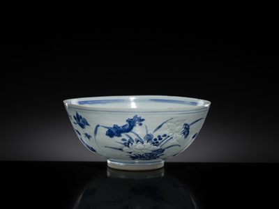 Lot 174 - A CARVED BLUE AND WHITE ‘FLORAL’ BOWL, TRANSITIONAL PERIOD, FROM THE HATCHER CARGO