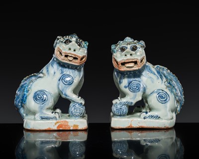 Lot 19 - A PAIR OF BLUE AND WHITE FIGURES OF BUDDHIST LIONS, LATE 16TH CENTURY