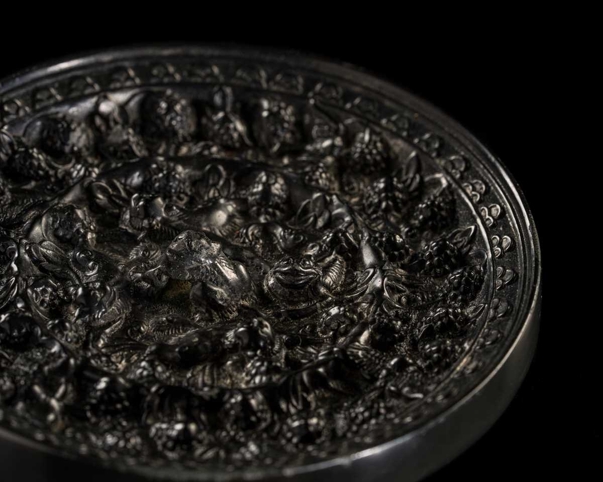 Lot 198 - A SMALL ‘LION AND GRAPEVINE’ BRONZE MIRROR, TANG DYNASTY