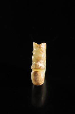 Lot 54 - A SMALL CELADON AND RUSSET JADE ‘PIG DRAGON’, ZHULONG, HONGSHAN CULTURE
