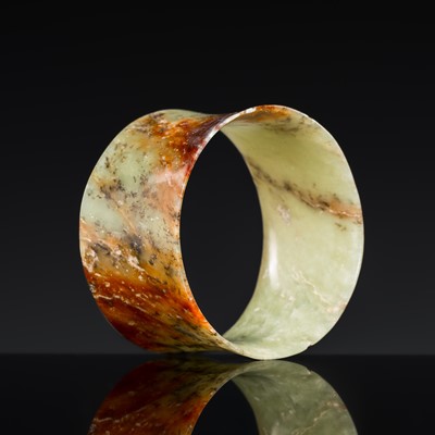 Lot 212 - A MOTTLED CELADON AND RUSSET JADE RING, NEOLITHIC PERIOD, LIANGZHU CULTURE