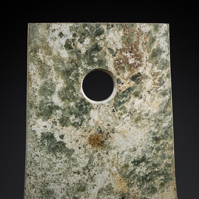 Lot 216 - A MOTTLED GREEN AND BROWN JADE AXE, YUE, NEOLITHIC PERIOD, LIANGZHU CULTURE
