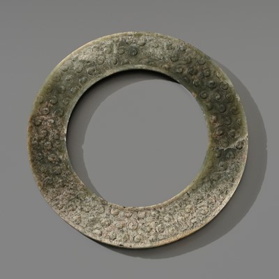 Lot 244 - A GREEN JADE DISC, YUAN, EASTERN ZHOU PERIOD