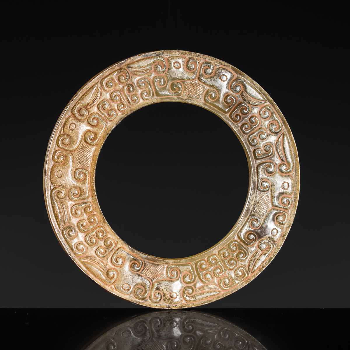 Lot 84 - A SMALL YELLOW JADE ‘DRAGONS’ RING, HUAN, EASTERN ZHOU, SPRING AND AUTUMN PERIOD