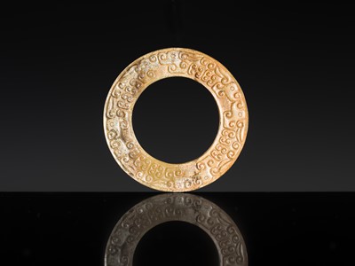 Lot 84 - A SMALL YELLOW JADE ‘DRAGONS’ RING, HUAN, EASTERN ZHOU, SPRING AND AUTUMN PERIOD