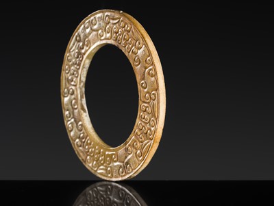 Lot 84 - A SMALL YELLOW JADE ‘DRAGONS’ RING, HUAN, EASTERN ZHOU, SPRING AND AUTUMN PERIOD