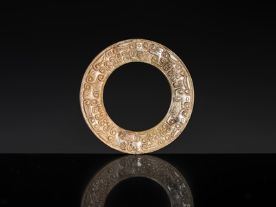 Lot 84 - A SMALL YELLOW JADE ‘DRAGONS’ RING, HUAN, EASTERN ZHOU, SPRING AND AUTUMN PERIOD